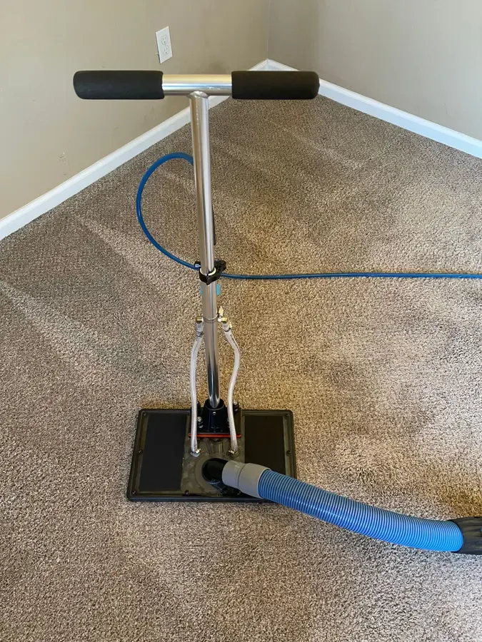 Flood extraction tool pulling water out of a wet carpet in a Golden home